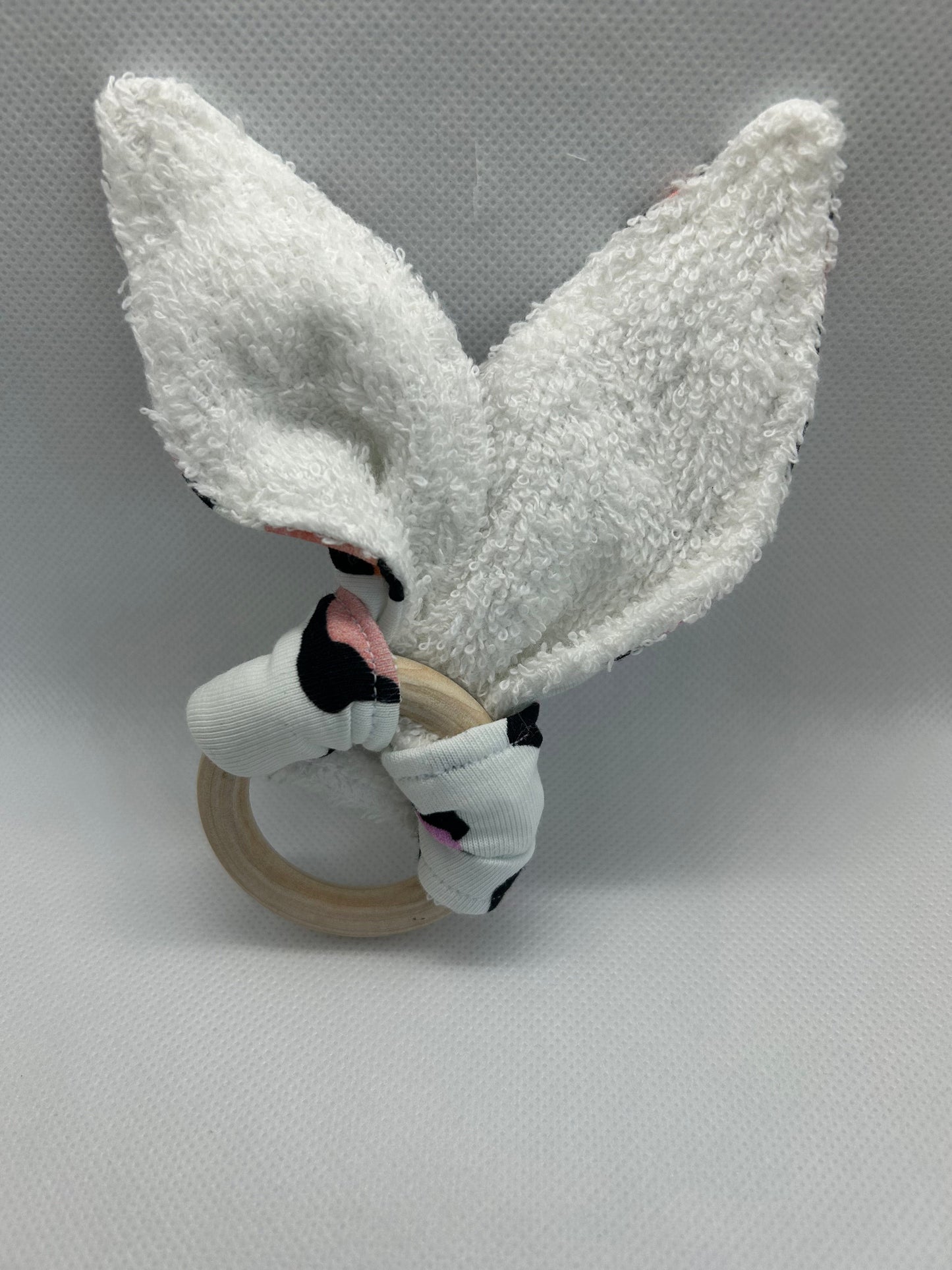 Baby rattle toy made from a baby safe soft jersey cotton and cotton towelling. A stimulating rattle in one side and crinkle paper in the other making very interactive, wrapped around a teething ring for safe chewing!