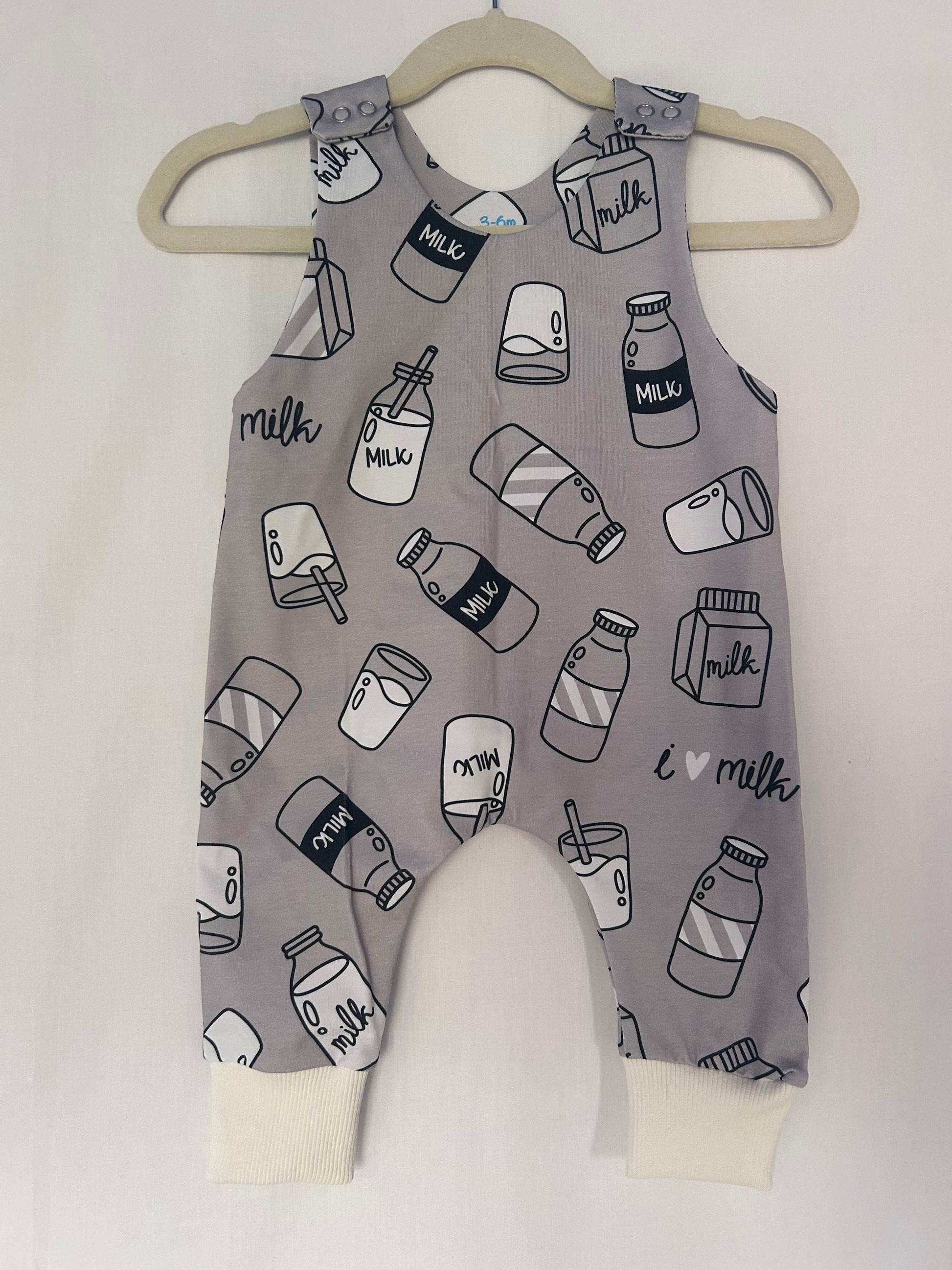 Monotone I Love Milk romper handmade for babies and toddlers, fun for running, jumping and climbing. Dungarees style outfit in a stretchy cotton fabric handmade in Oxfordshire.