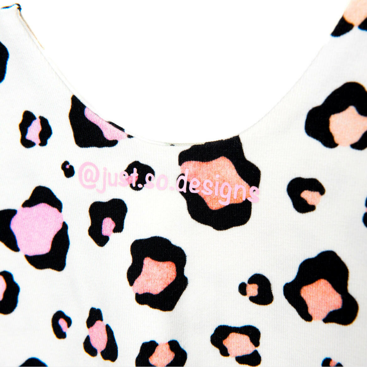 Pink pastel leopard print romper handmade for babies and toddlers, fun for running, jumping and climbing. Dungarees style outfit in a stretchy cotton fabric handmade in Oxfordshire
