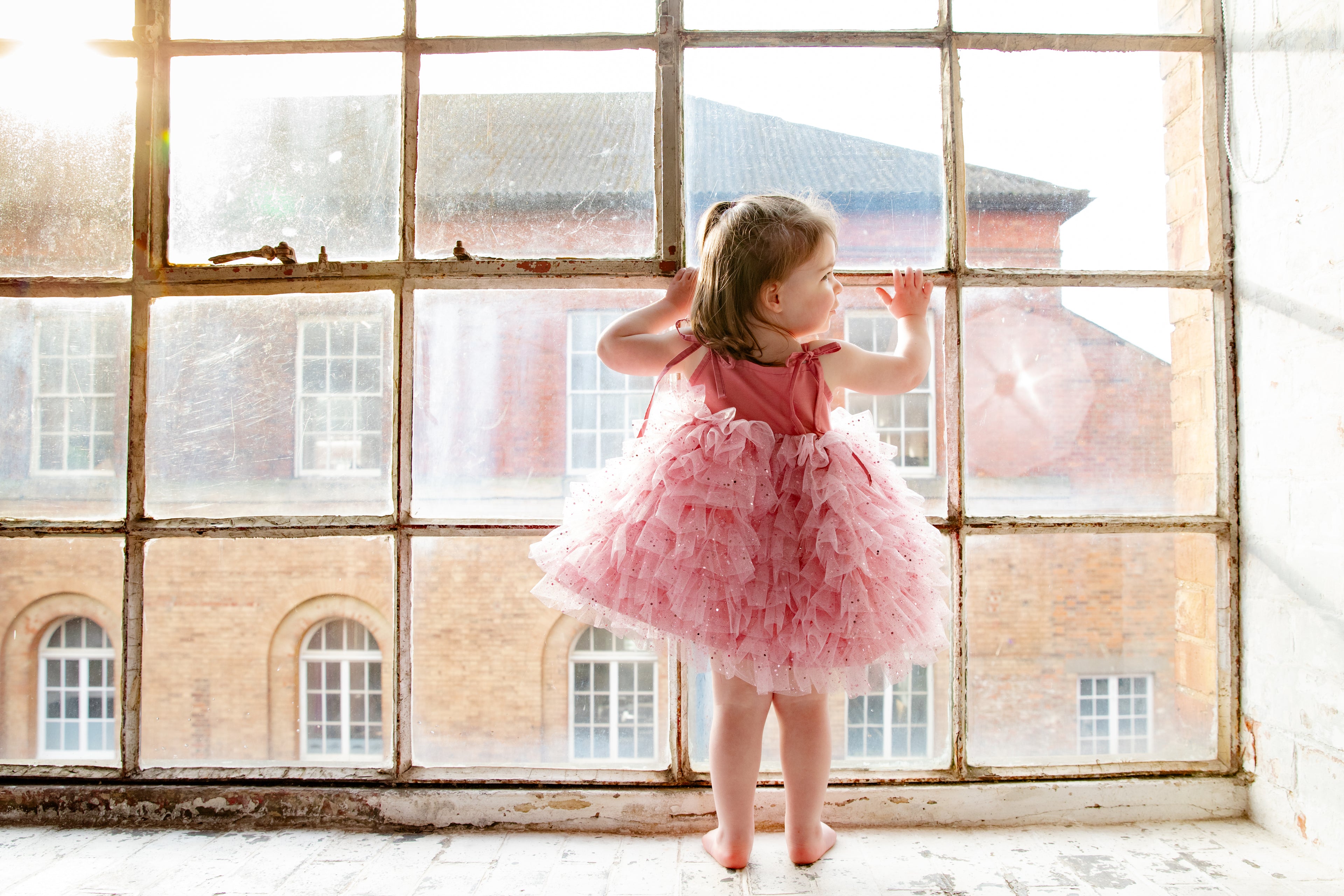 This handmade bespoke dress dazzles with layers of soft tulle, delicate sparkles, and a fitted bodice. Perfect for birthdays, photoshoots or fairy tale adventures.