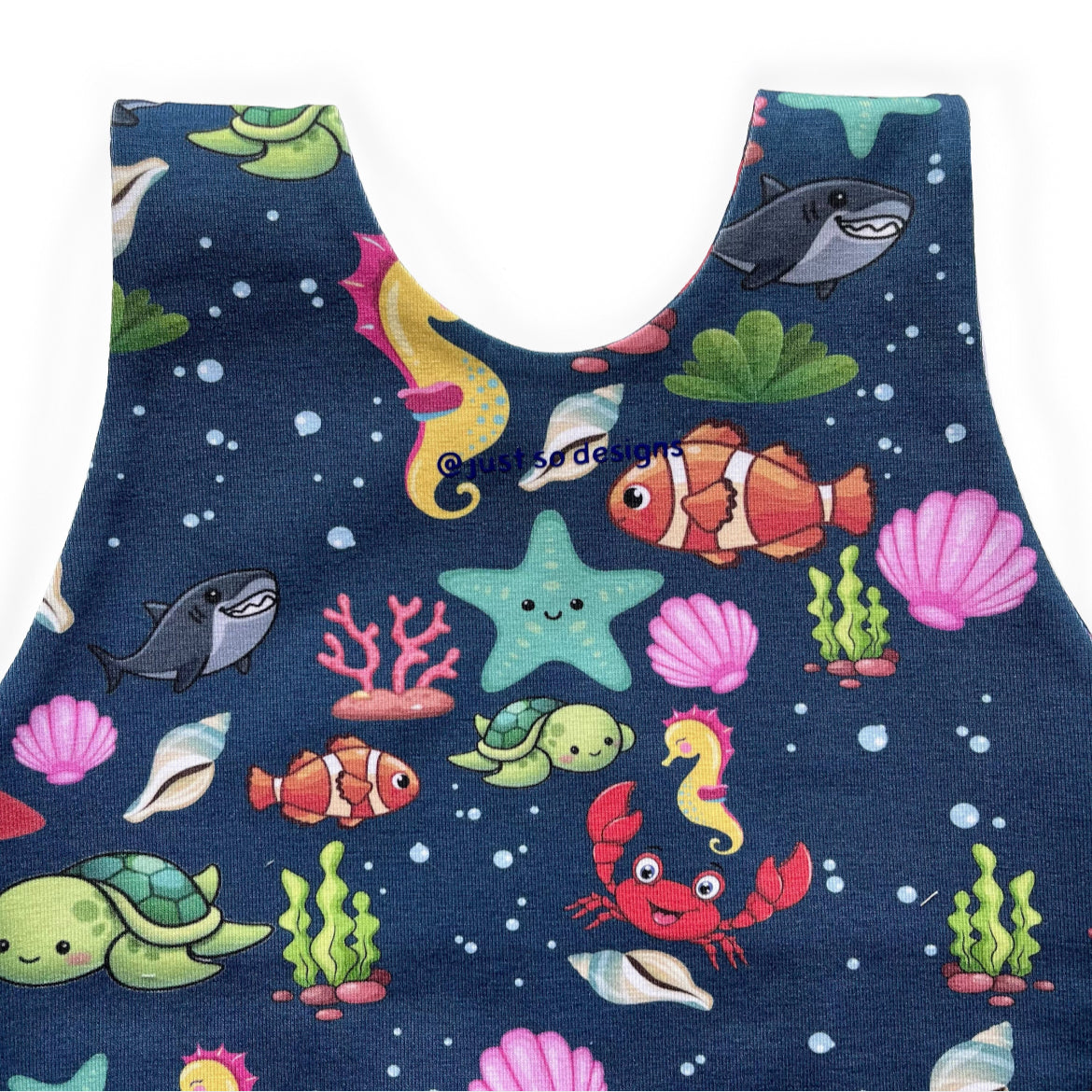 Blue sea animal romper handmade for babies and toddlers, fun for running, jumping and climbing. Dungarees style outfit in a stretchy cotton fabric handmade in Oxfordshire.