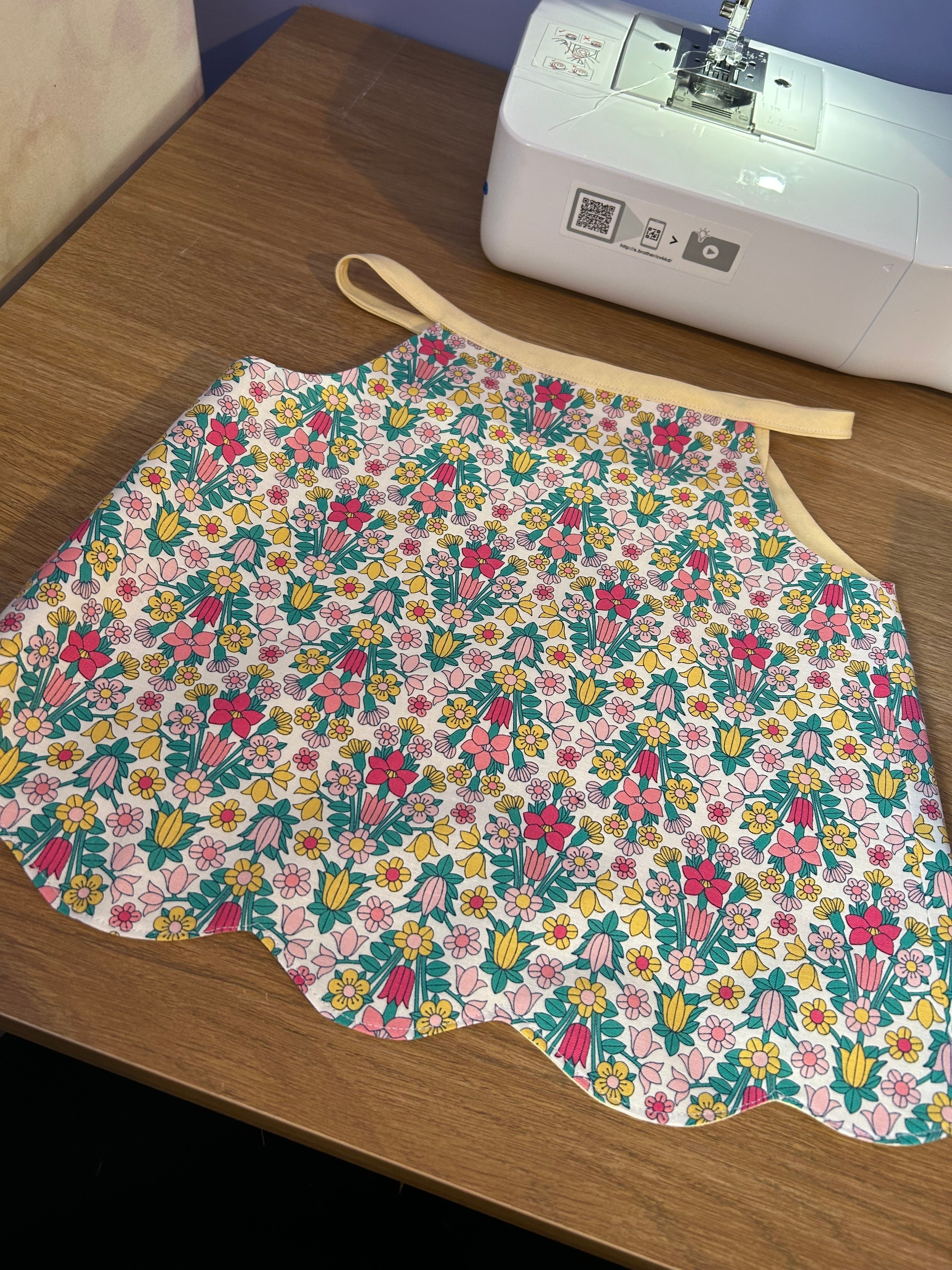 Handmade cotton top with a scalloped hem and vibrant floral print. Lightweight, breathable and perfect for adding a cheerful touch to any outfit