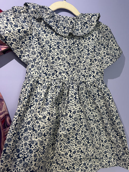 Handmade girls navy blue floral print dress with ruffle neckline and button front. Unique, comfy children's clothing made in the UK
