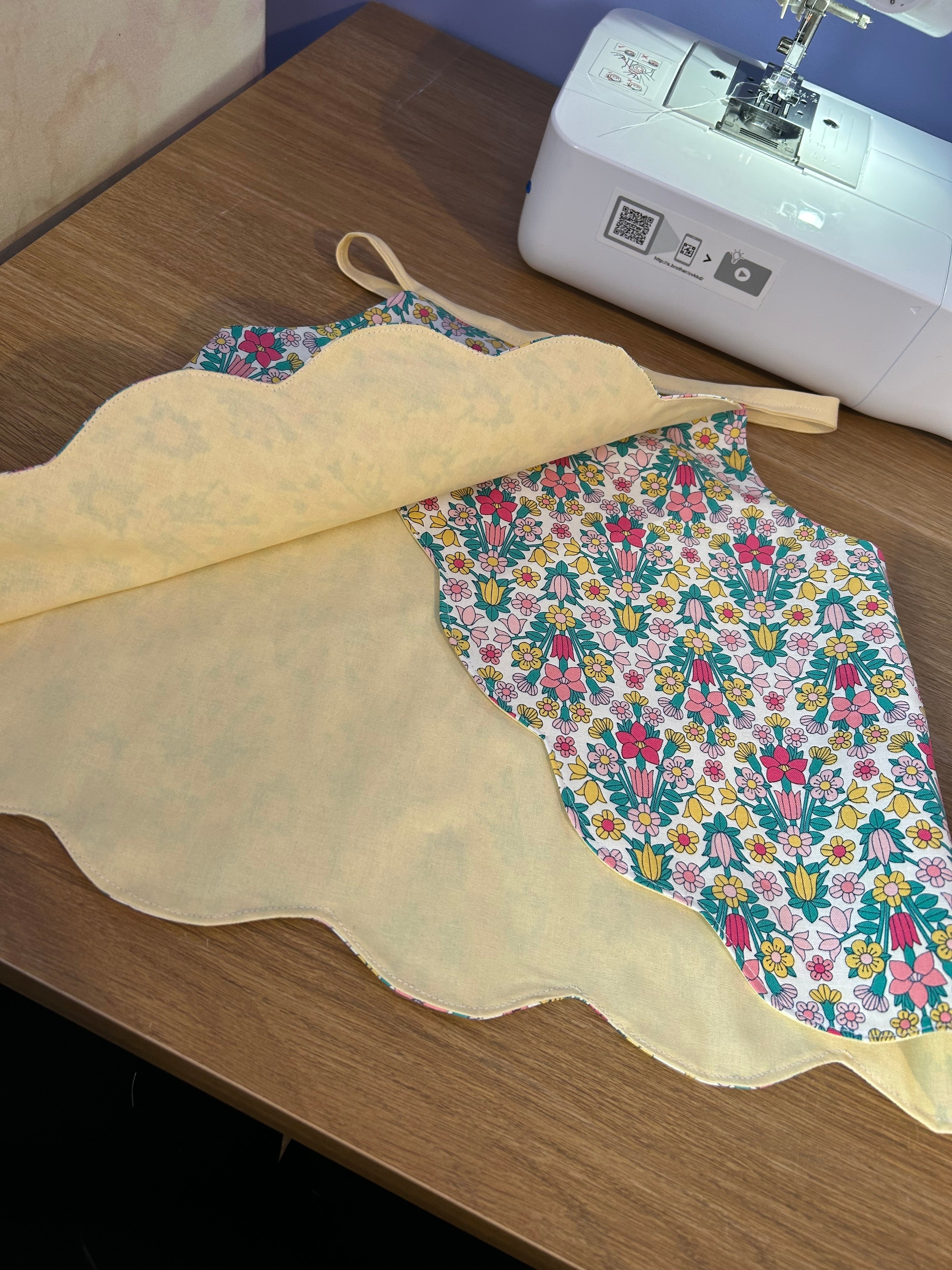 Handmade cotton top with a scalloped hem and vibrant floral print. Lightweight, breathable and perfect for adding a cheerful touch to any outfit