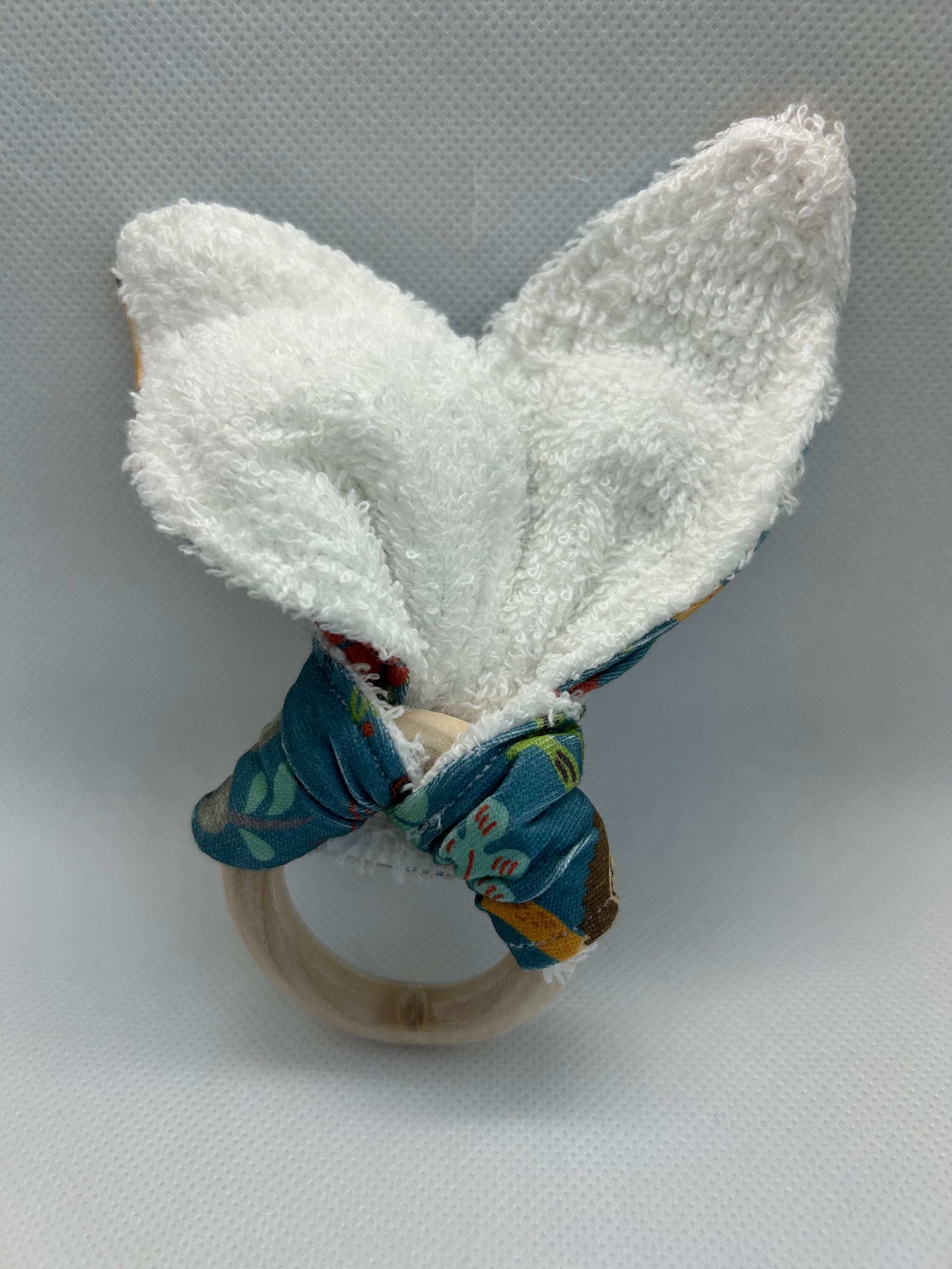Baby rattle toy made from a baby safe soft jersey cotton and cotton towelling. A stimulating rattle in one side and crinkle paper in the other making very interactive, wrapped around a teething ring for safe chewing!