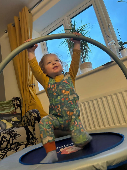 Jungle Animal print romper handmade for babies and toddlers, fun for running, jumping and climbing. Dungarees style outfit in a stretchy cotton fabric handmade in Oxfordshire.