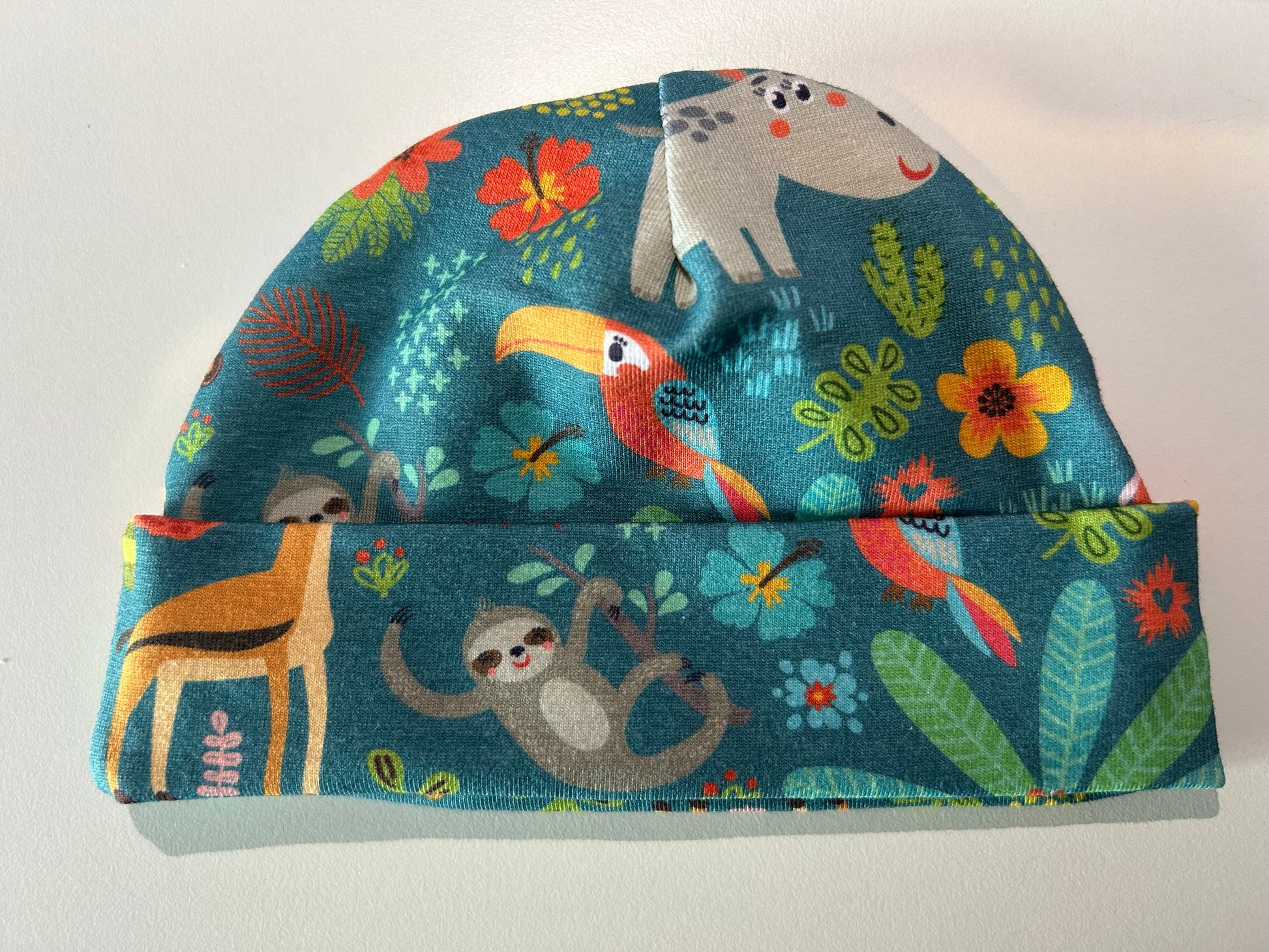 Baby hat with jungle animal pattern, handmade in Oxfordshire