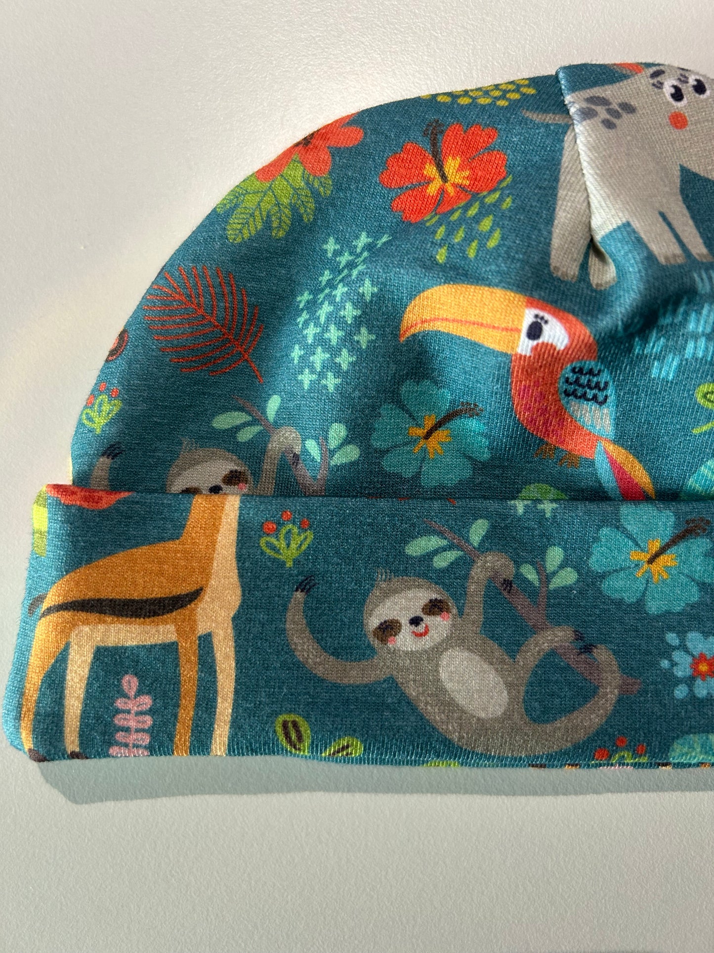 Baby hat with jungle animal pattern, handmade in Oxfordshire