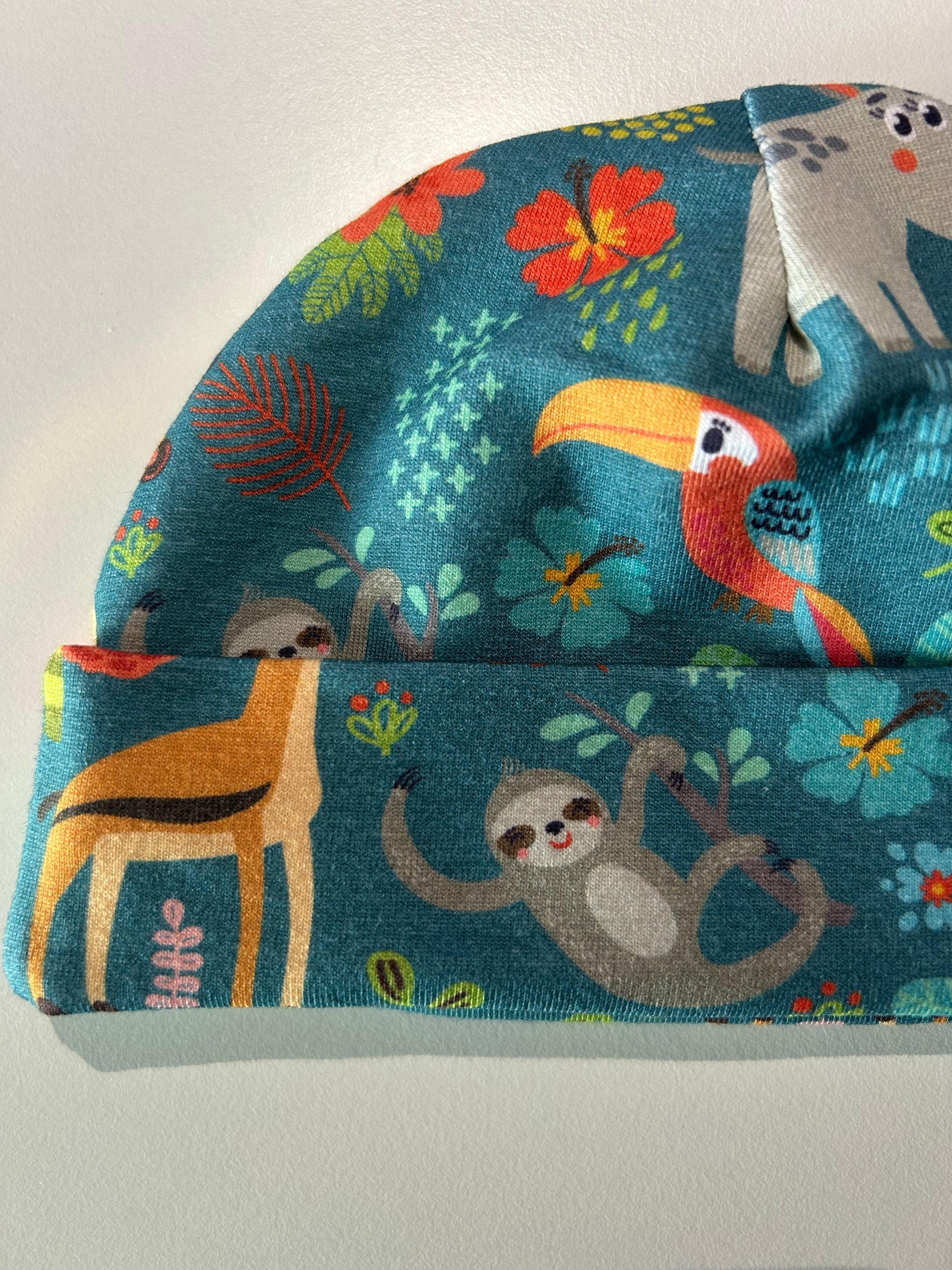 Baby hat with jungle animal pattern, handmade in Oxfordshire