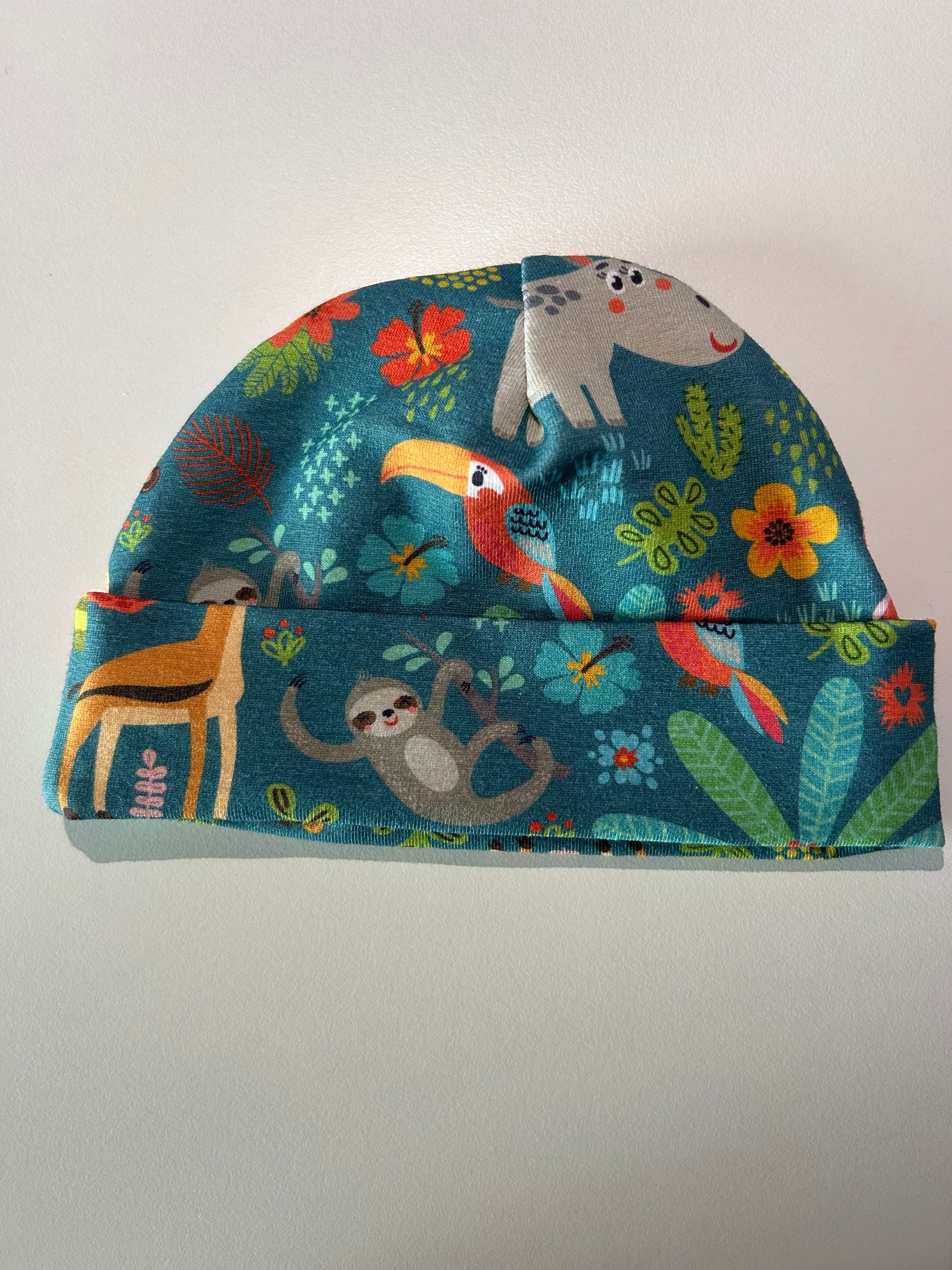 Baby hat with jungle animal pattern, handmade in Oxfordshire