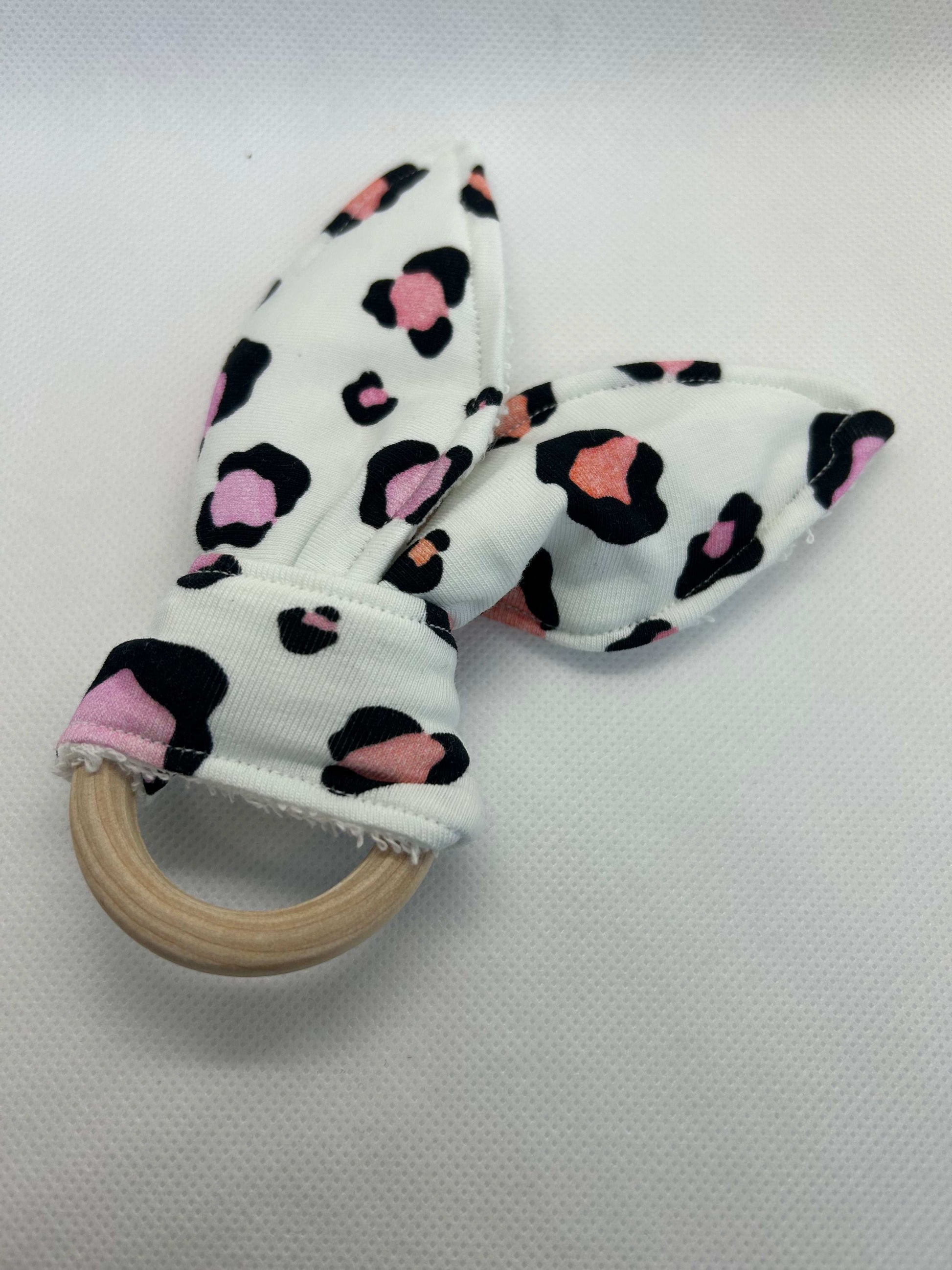 Baby rattle toy made from a baby safe soft jersey cotton and cotton towelling. A stimulating rattle in one side and crinkle paper in the other making very interactive, wrapped around a teething ring for safe chewing!