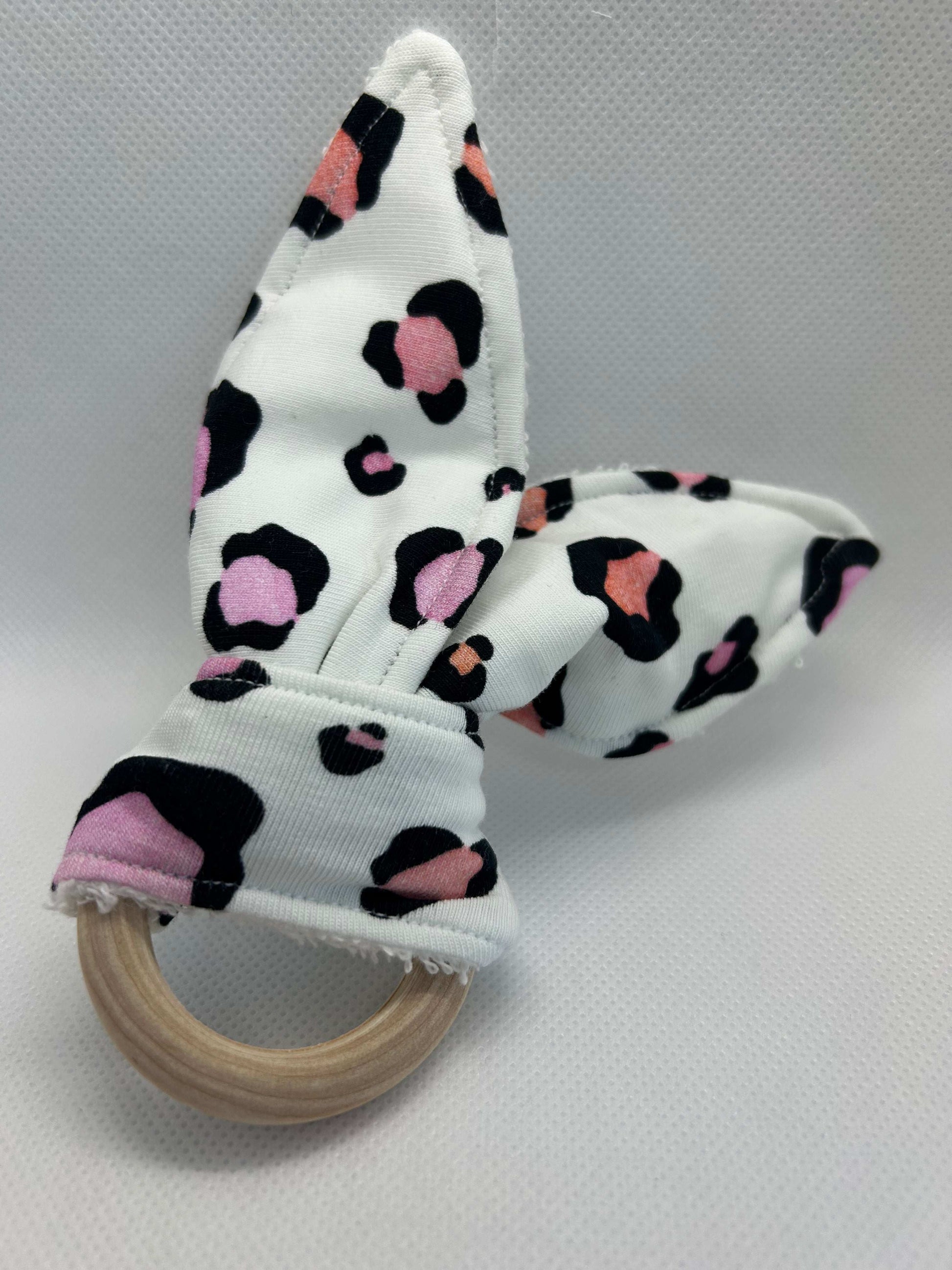 Baby rattle toy made from a baby safe soft jersey cotton and cotton towelling. A stimulating rattle in one side and crinkle paper in the other making very interactive, wrapped around a teething ring for safe chewing!