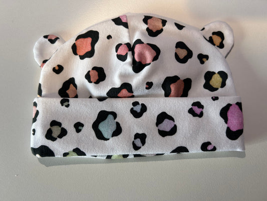 Baby hat with pastel leopard pattern, handmade in Oxfordshire