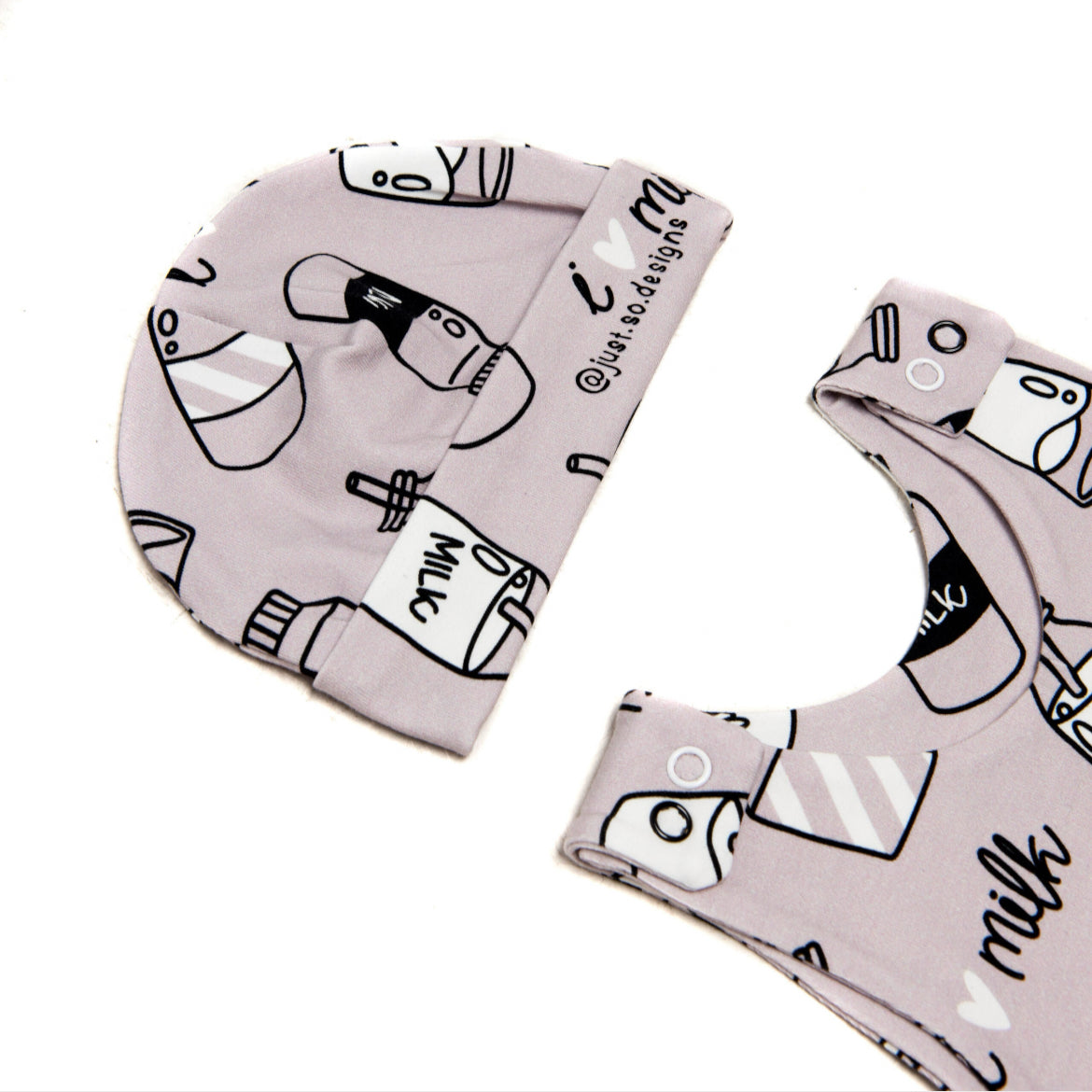 A cute little newborn hat with a monochrome neutral I Love Milk Print to match the comfy romper