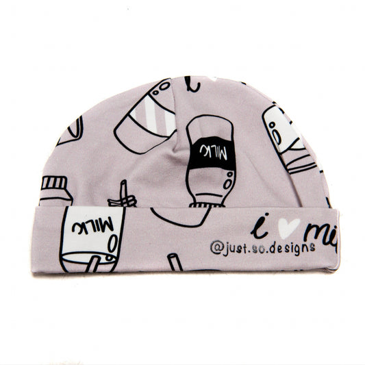 A cute little newborn hat with a monochrome neutral I Love Milk Print to match the comfy romper