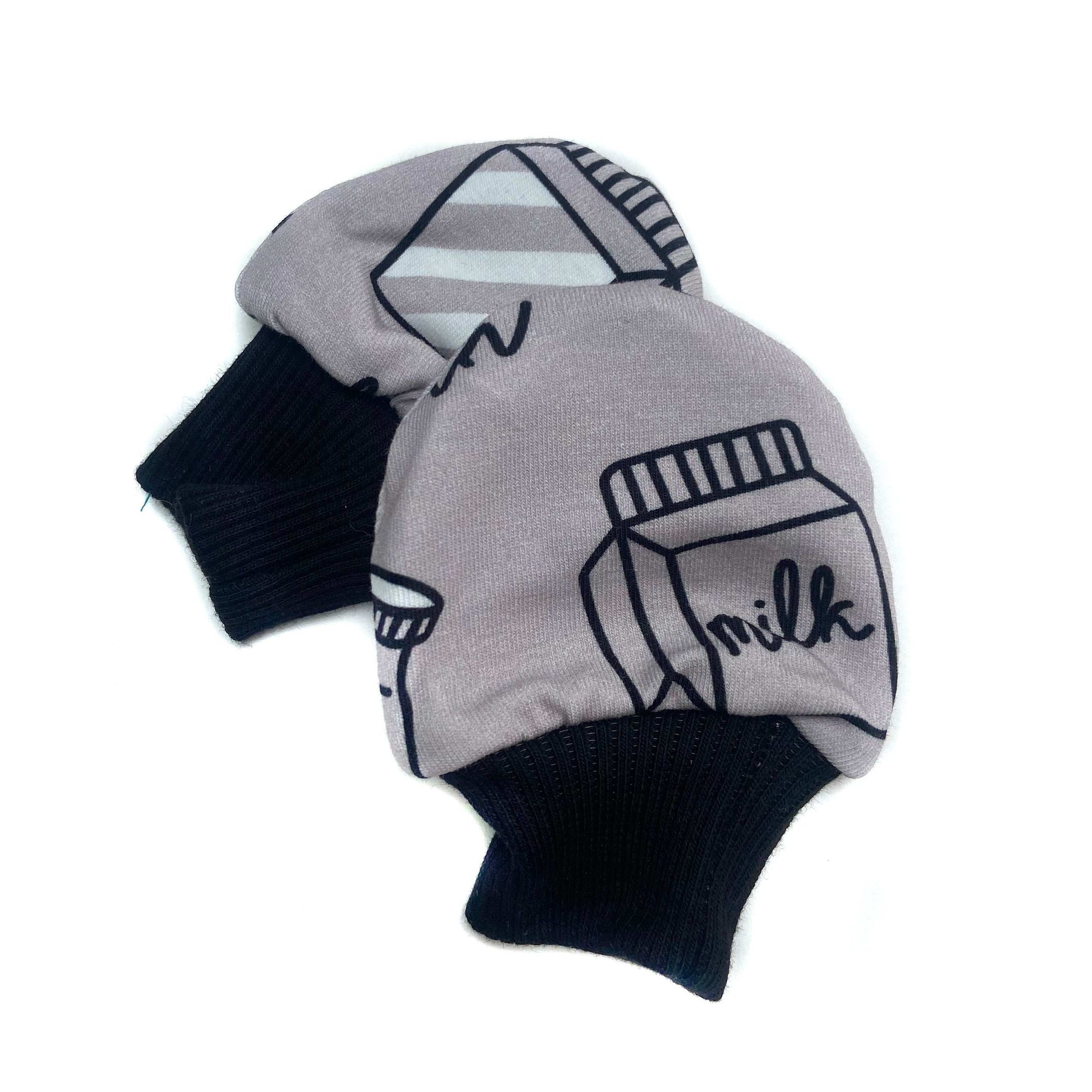 Gorgeous little baby mittens in a bold monochrome milk print, perfect for baby gifts, growing hands to give plenty of movement and to match outfits. 