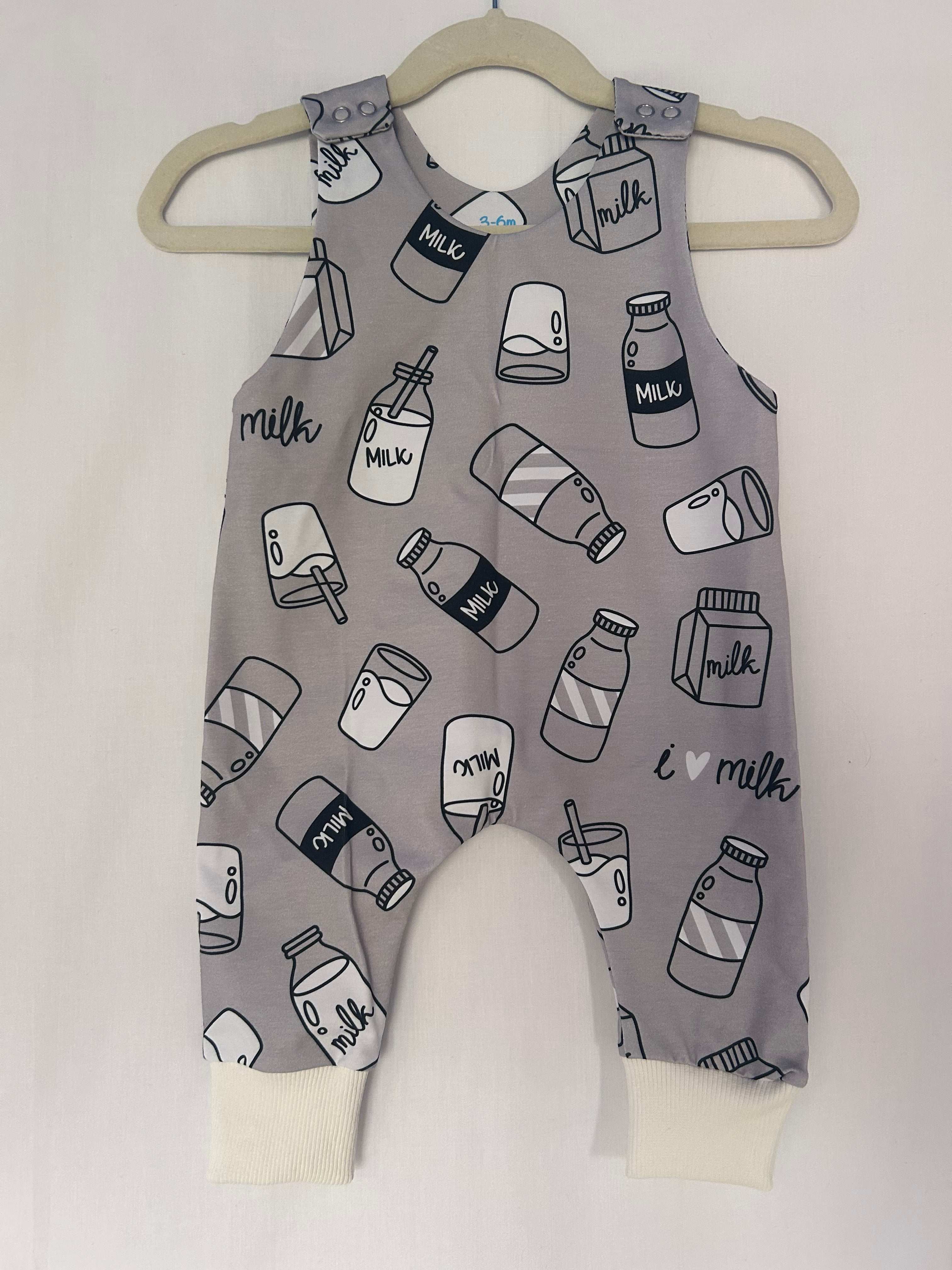 Monotone I Love Milk romper handmade for babies and toddlers, fun for running, jumping and climbing. Dungarees style outfit in a stretchy cotton fabric handmade in Oxfordshire.