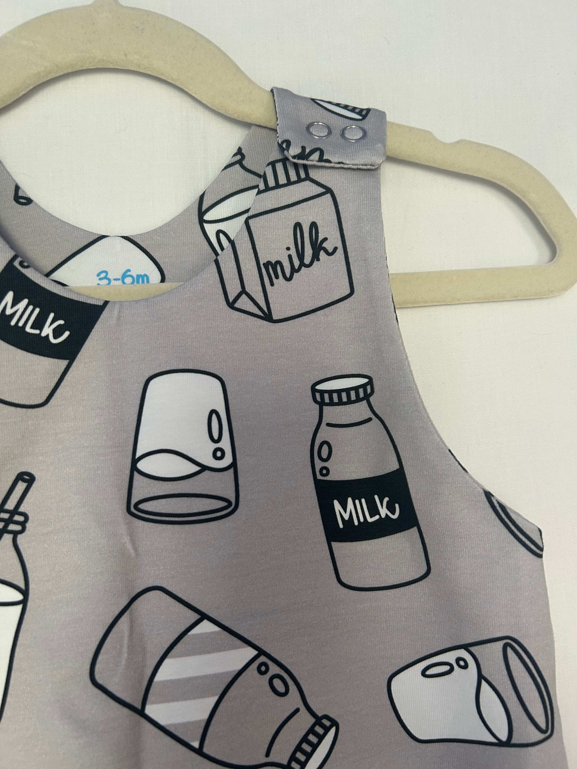 Monotone I Love Milk romper handmade for babies and toddlers, fun for running, jumping and climbing. Dungarees style outfit in a stretchy cotton fabric handmade in Oxfordshire.