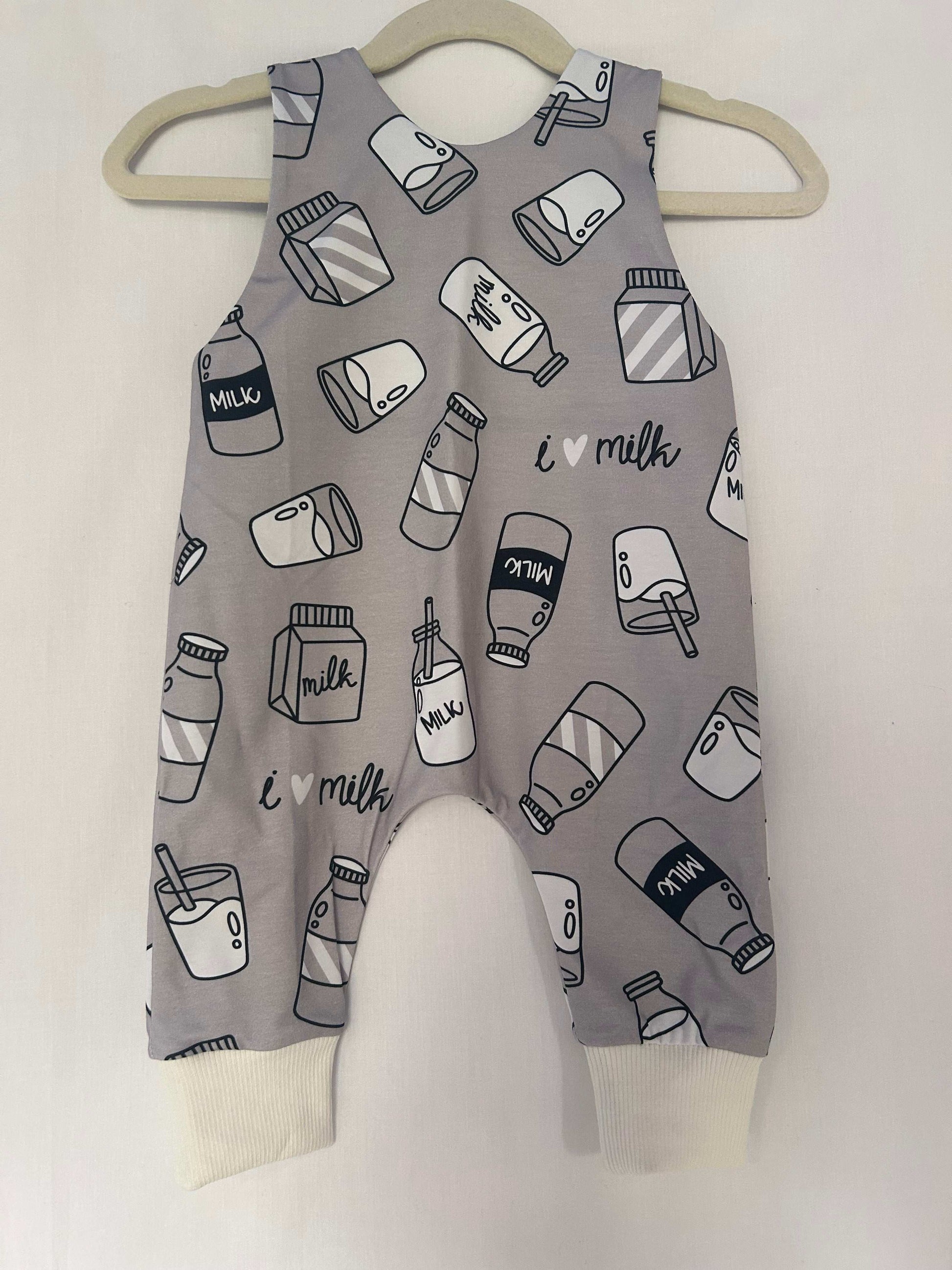 Monotone I Love Milk romper handmade for babies and toddlers, fun for running, jumping and climbing. Dungarees style outfit in a stretchy cotton fabric handmade in Oxfordshire.