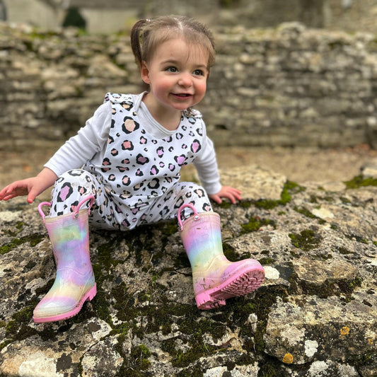 Pink pastel leopard print romper handmade for babies and toddlers, fun for running, jumping and climbing. Dungarees style outfit in a stretchy cotton fabric handmade in Oxfordshire