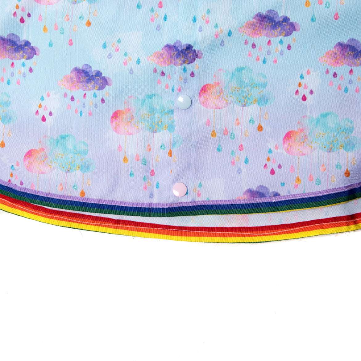 Keep little adventurers dry in style with this handmade waterproof cape, featuring a playful umbrella print, rainbow trim and roomy fit for carefree outdoor fun in any weather.