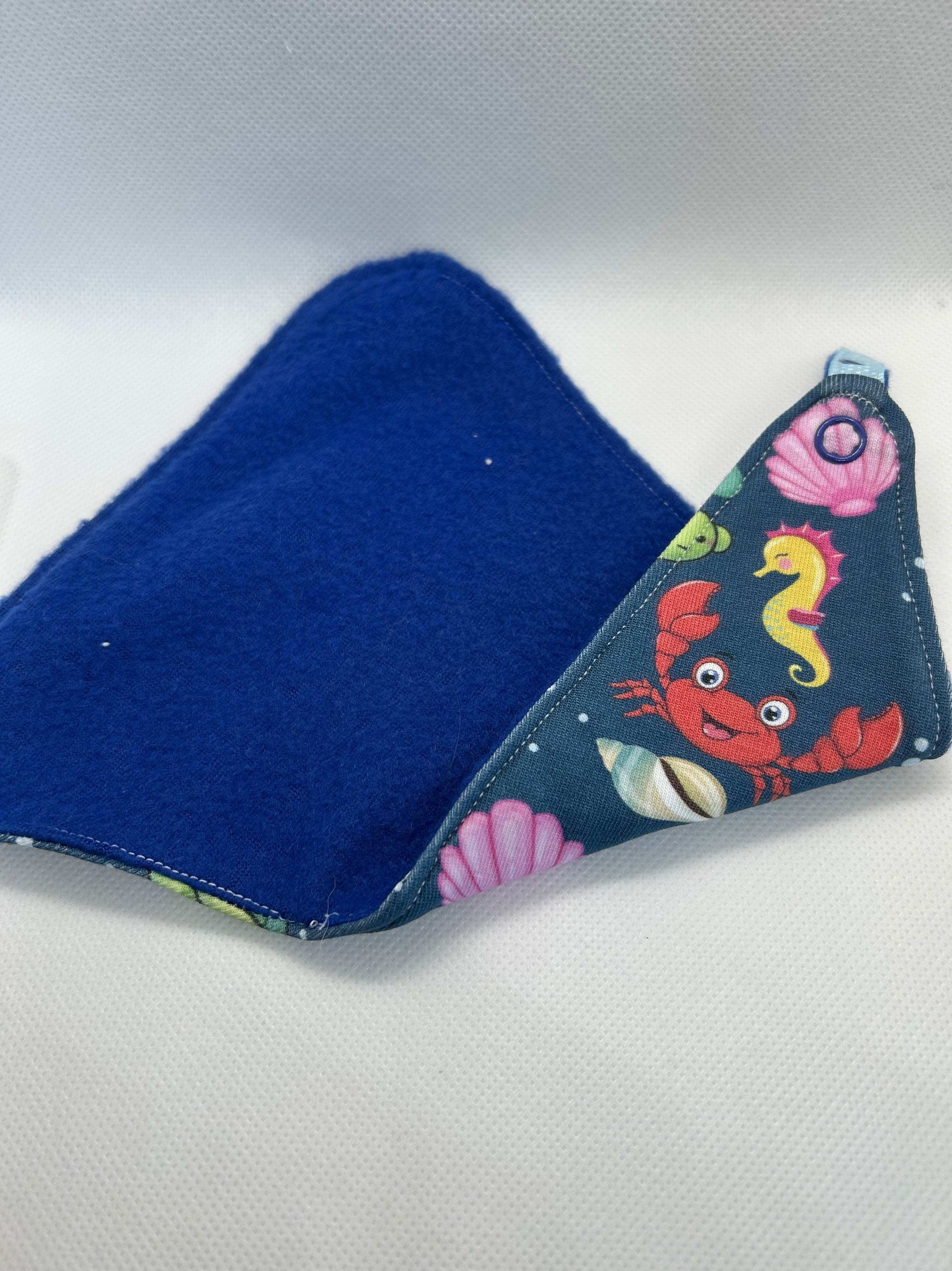 Handmade dummy comforter is the perfect soothing companion. Crafted from soft, baby safe jersey cotton and fleece. Keeps dummies and pacifiers close whilst offering cuddly comfort for little ones.
