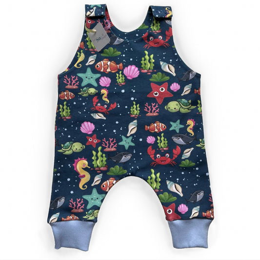 Sea animal print romper handmade for babies and toddlers, fun for running, jumping and climbing. Dungarees style outfit in a stretchy cotton fabric handmade in Oxfordshire.