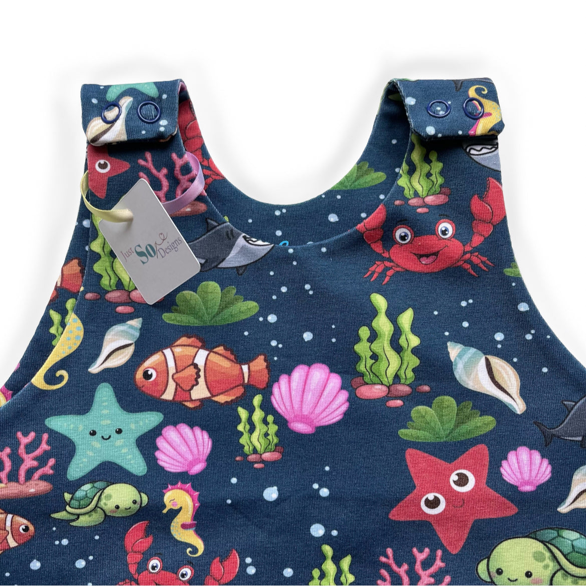 Blue sea animal romper handmade for babies and toddlers, fun for running, jumping and climbing. Dungarees style outfit in a stretchy cotton fabric handmade in Oxfordshire.