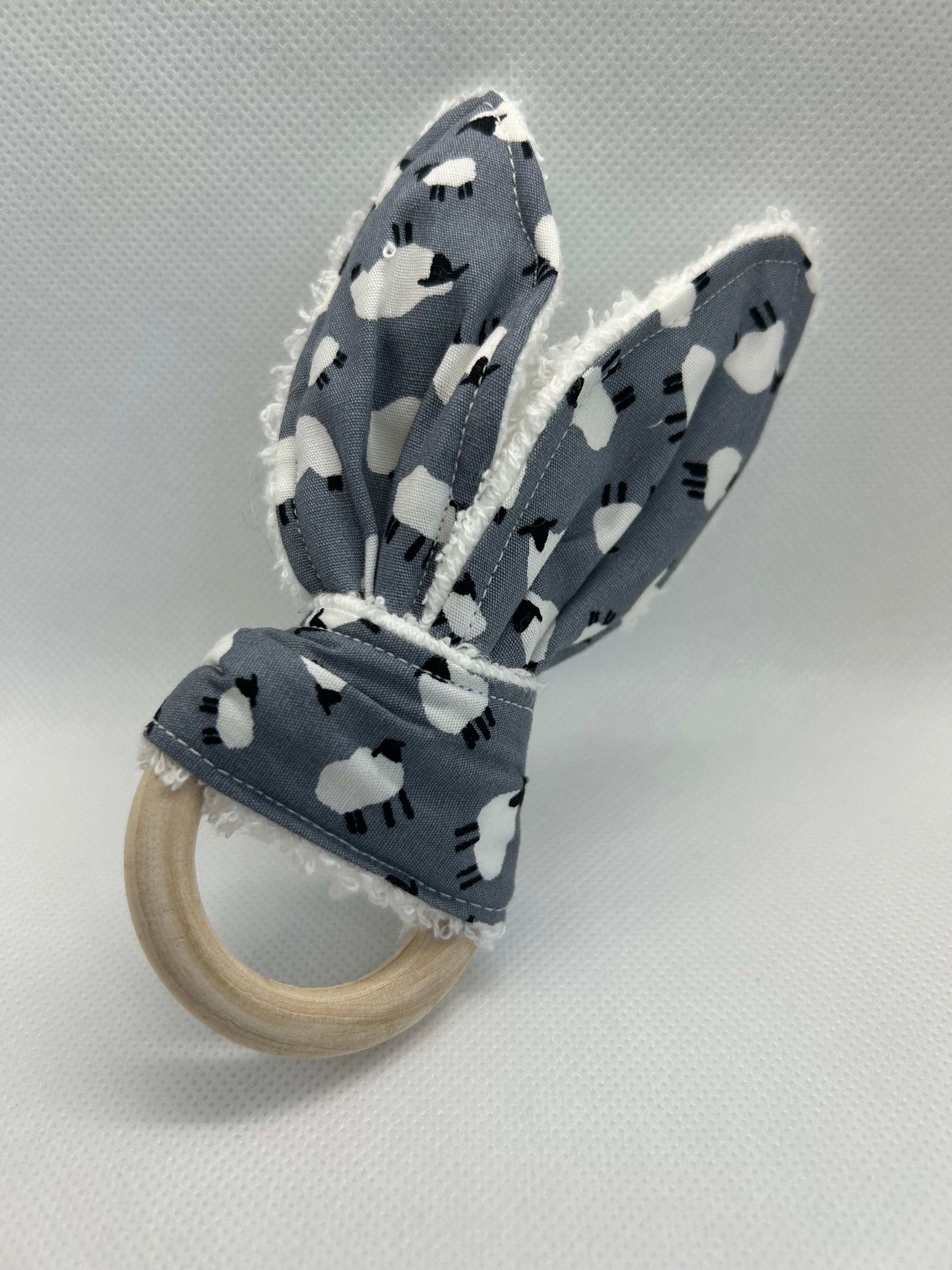 Baby rattle toy made from a baby safe soft jersey cotton and cotton towelling. A stimulating rattle in one side and crinkle paper in the other making very interactive, wrapped around a teething ring for safe chewing!