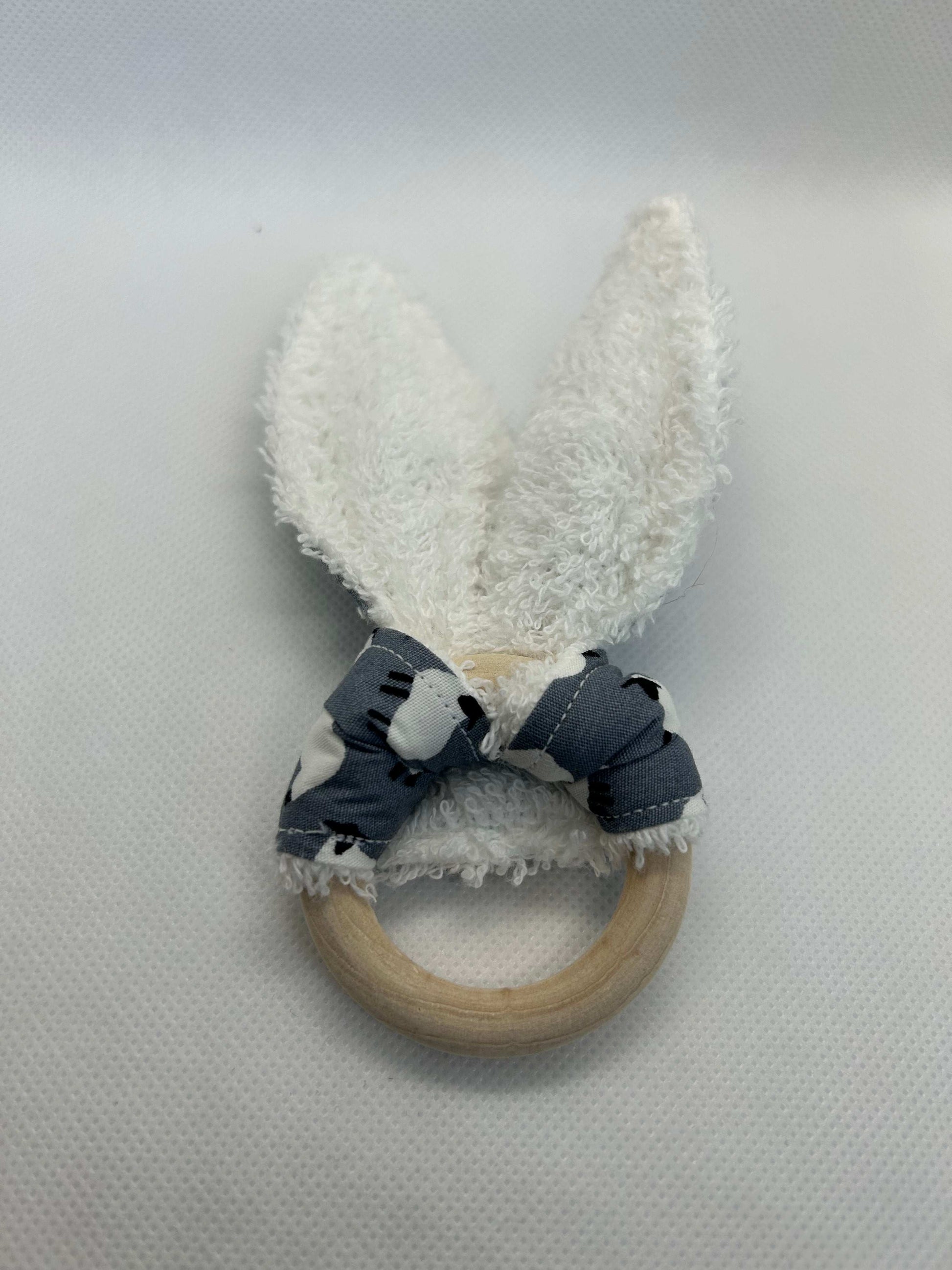 Baby rattle toy made from a baby safe soft jersey cotton and cotton towelling. A stimulating rattle in one side and crinkle paper in the other making very interactive, wrapped around a teething ring for safe chewing!