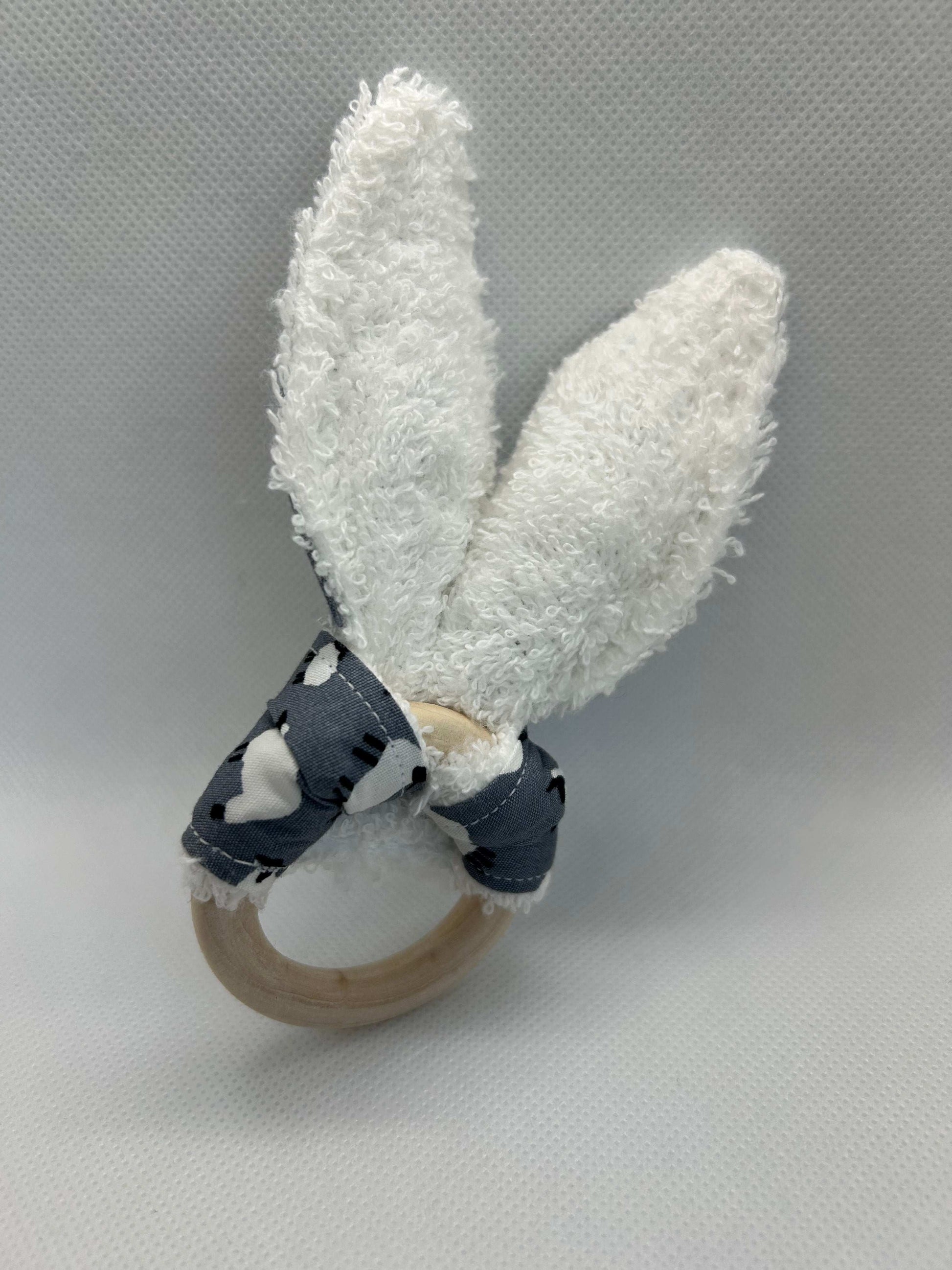 Baby rattle toy made from a baby safe soft jersey cotton and cotton towelling. A stimulating rattle in one side and crinkle paper in the other making very interactive, wrapped around a teething ring for safe chewing!