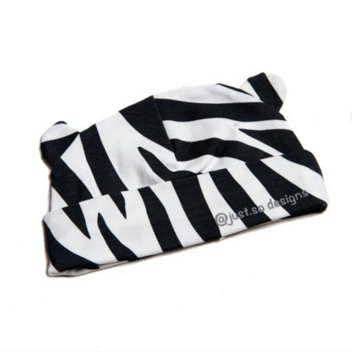 Keep your little one cozy and cute in our handmade zebra-print beanie with playful ears. Made with soft, stretchy fabric for comfort and style. Perfect for everyday wear!