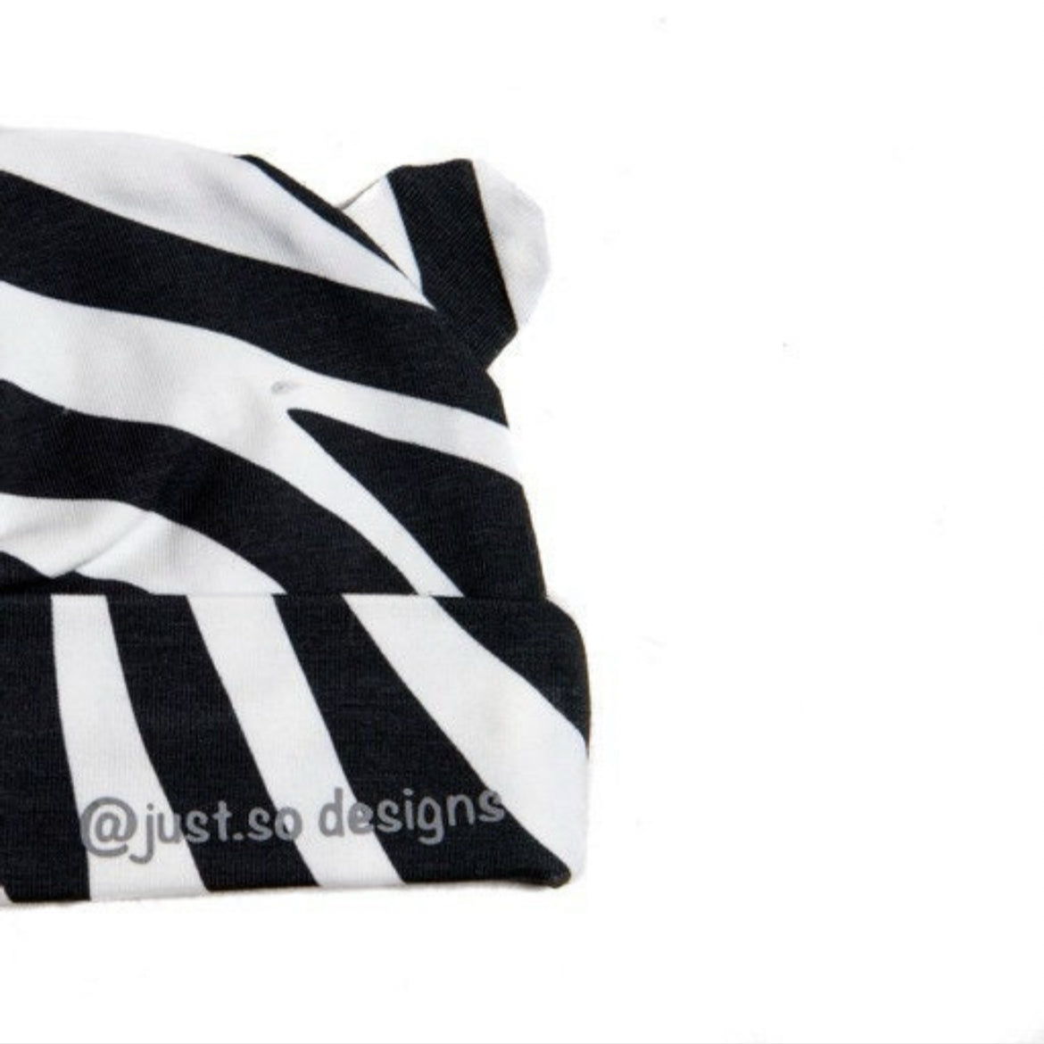 Keep your little one cozy and cute in our handmade zebra-print beanie with playful ears. Made with soft, stretchy fabric for comfort and style. Perfect for everyday wear!