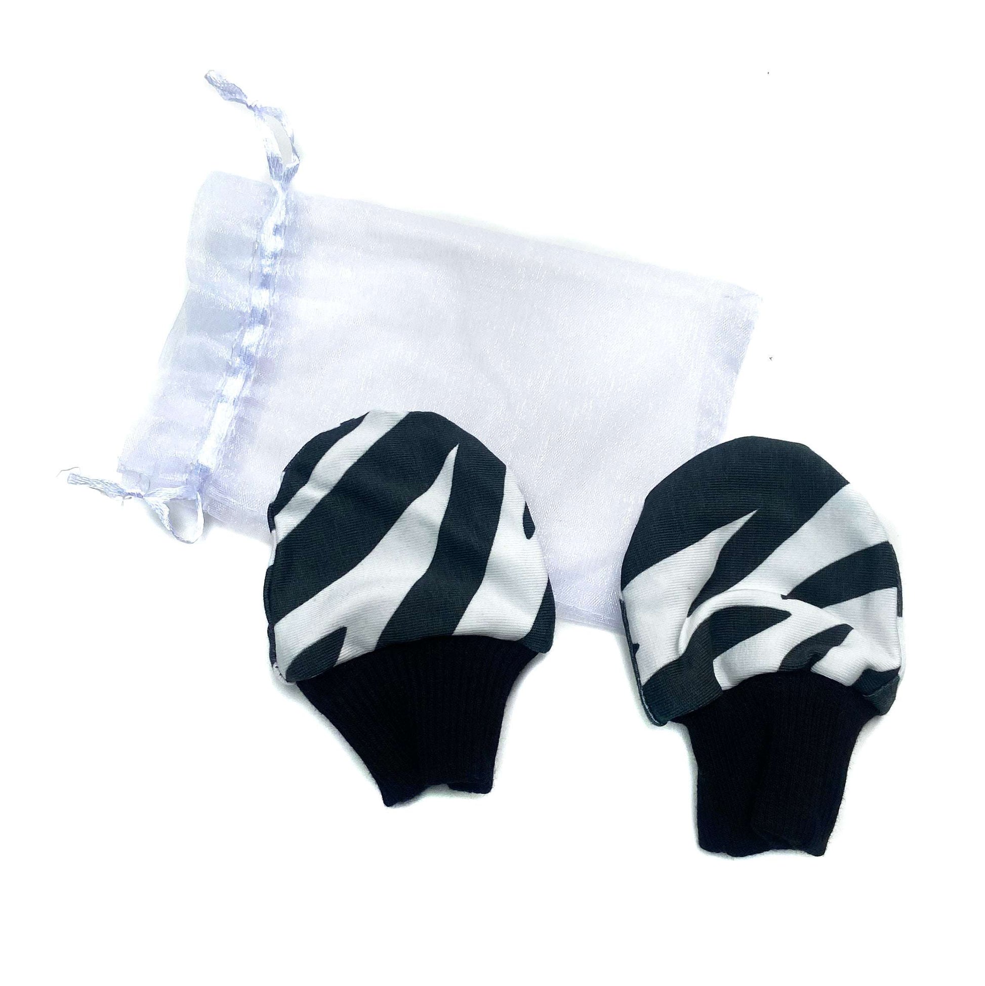 Gorgeous little baby mittens in a bold monochrome zebra print, perfect for baby gifts, growing hands to give plenty of movement and to match outfits. 